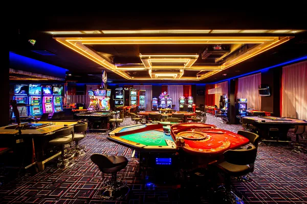 A player using their smartphone during a festive local event, representing GGGJL’s fully mobile-friendly casino.